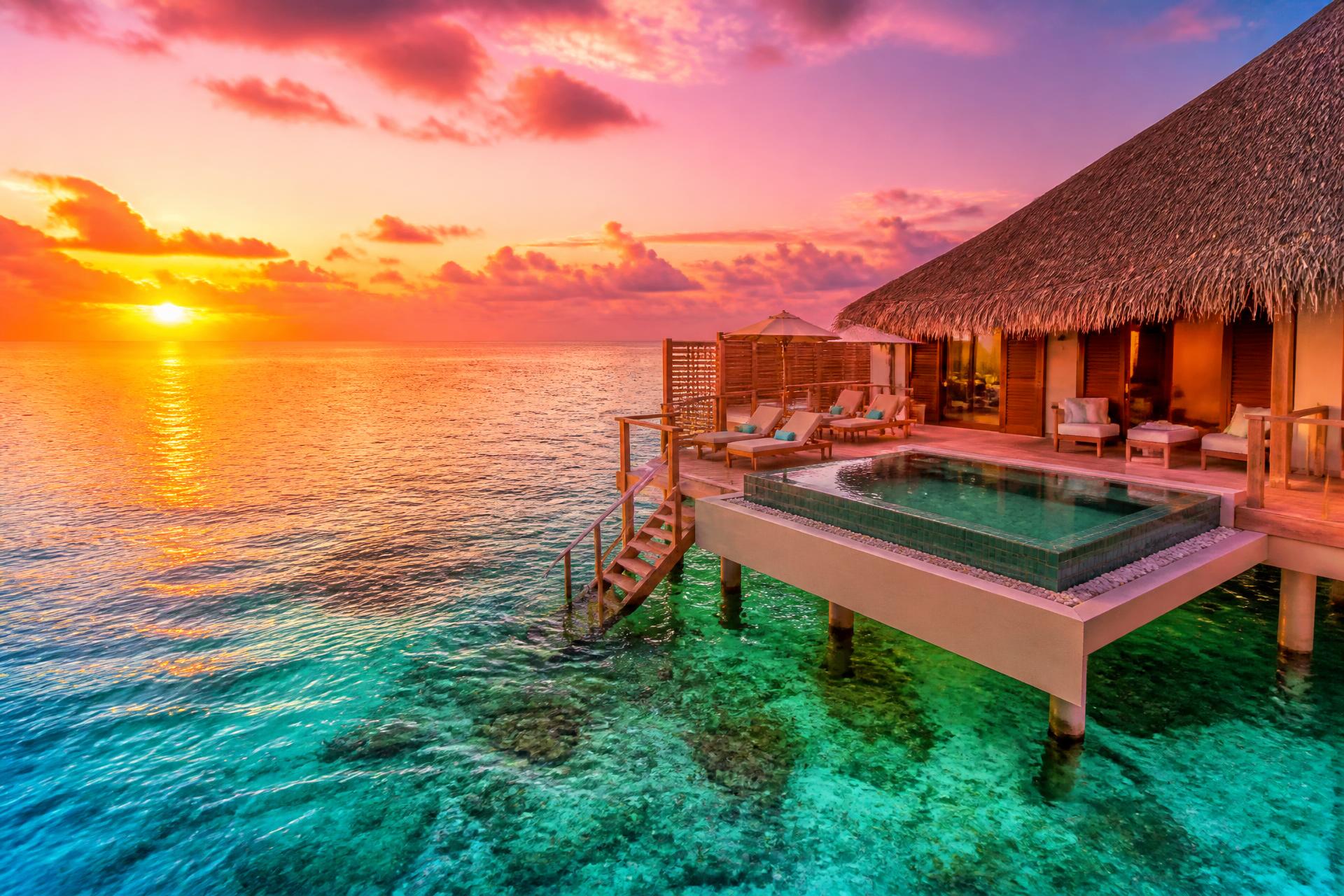 Private overwater villa in the Maldives at golden hour